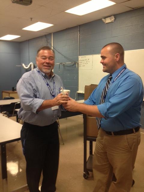 A MILKSHAKE AND A THANK YOU-- Coach Mickey McCuiston (L) receives a milkshake from Principal Matthew Madding in recognition of high faculty attendance.