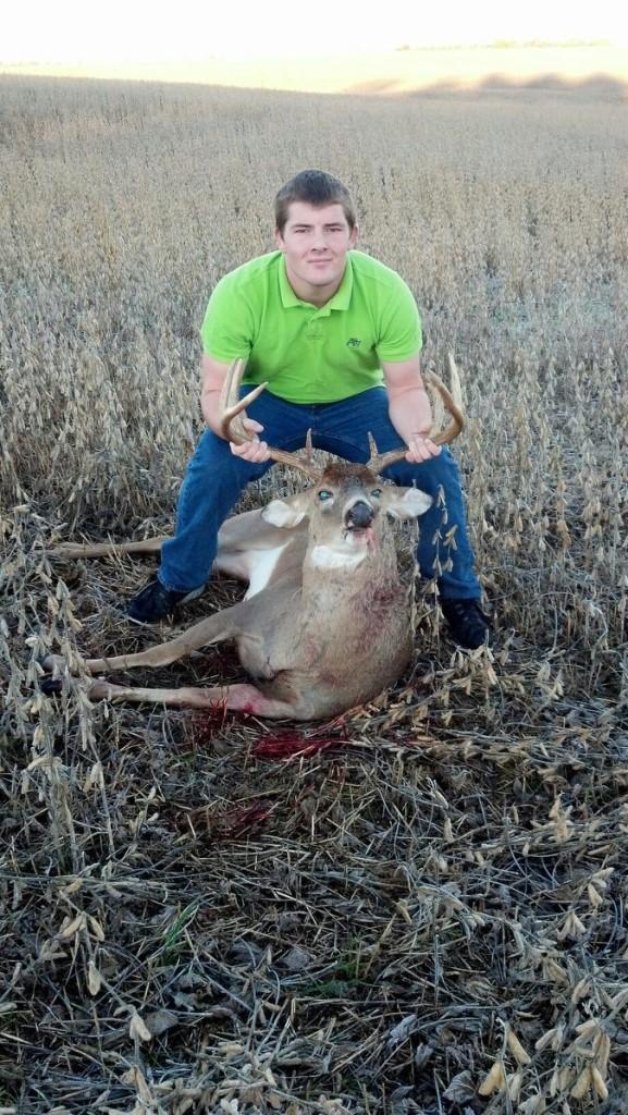 TROPHY BUCK-- Junior Colin Feezor shows off a buck that wondered a little too close to his home before school last week.
