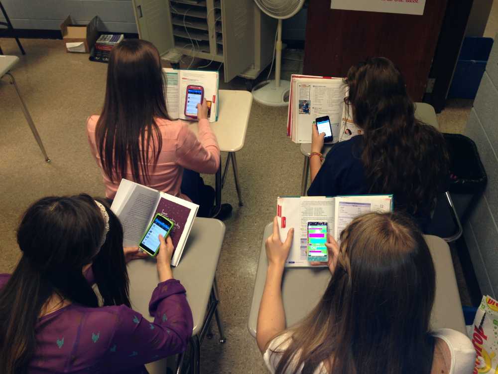 ADDICTED-- Many students are so dependent on their phones that they cant stand going through a single class period without stealing a look at their device.