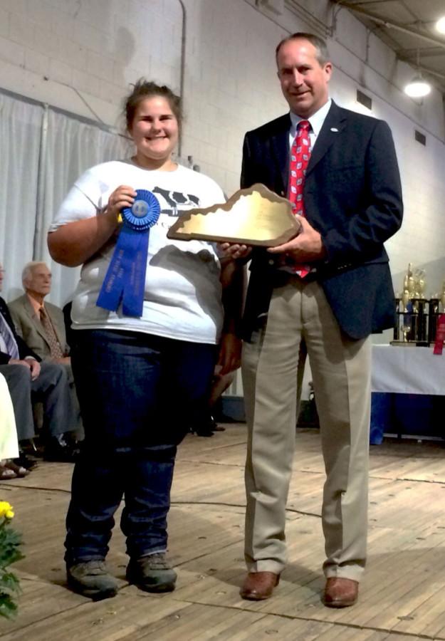 BLUE RIBBON WINNER-- Junior Katie Elder shows off her successes at the State Fair.