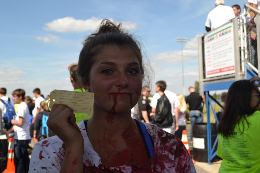 TAG-- Senior Bethany Cartwright poses with her toe tag, after she reenacted the fatality in an ATV crash simulation at Wednesdays Ag Safety Day Pep Rally for Life. 