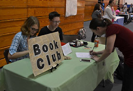 Juniors Becca Green and David Adams man the Book Club table at Rush Week.