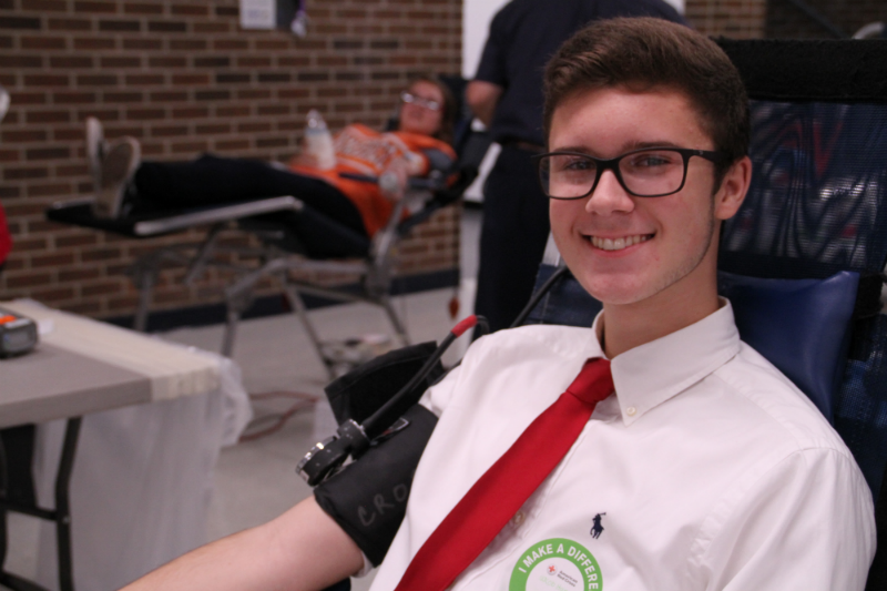 ALL SMILES-- Junior Jacob Hansen prepares to make his donation. One donation can potentially help more than one patient.