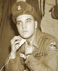CLEAN SHAVE-- A vintage photo shows Elvis Presley shaving during his service in the US Army.