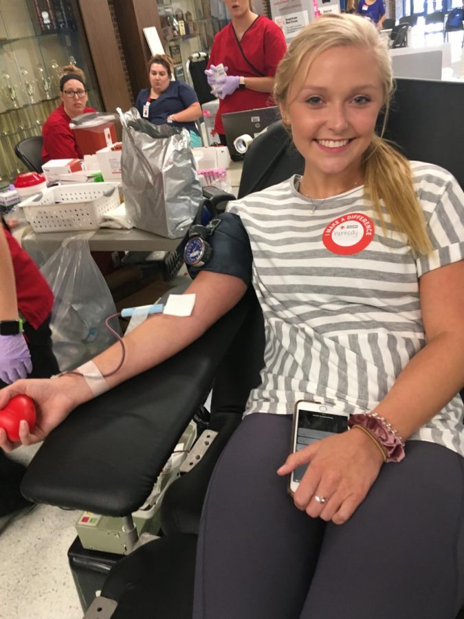 Senior, Kennedy Goodman, in the process of giving blood this afternoon