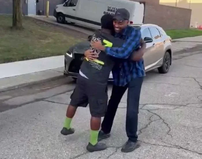 Ron Hilliard and Brandon Fails smiling during a surprise reunion after 25 years