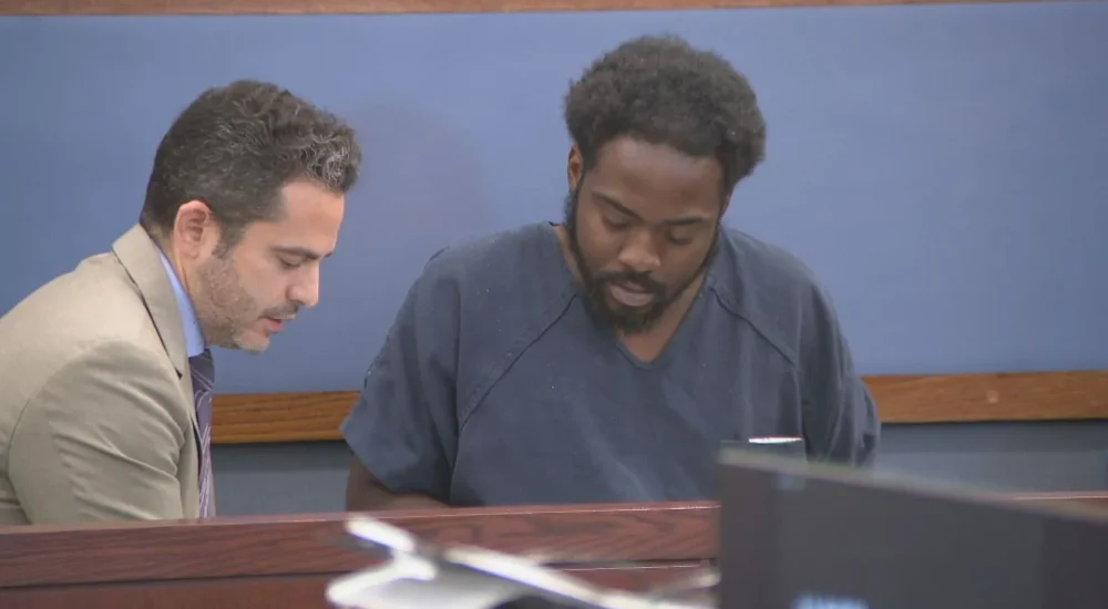 Rodger Harrison III speaks with his public defender before a Las Vegas court hearing