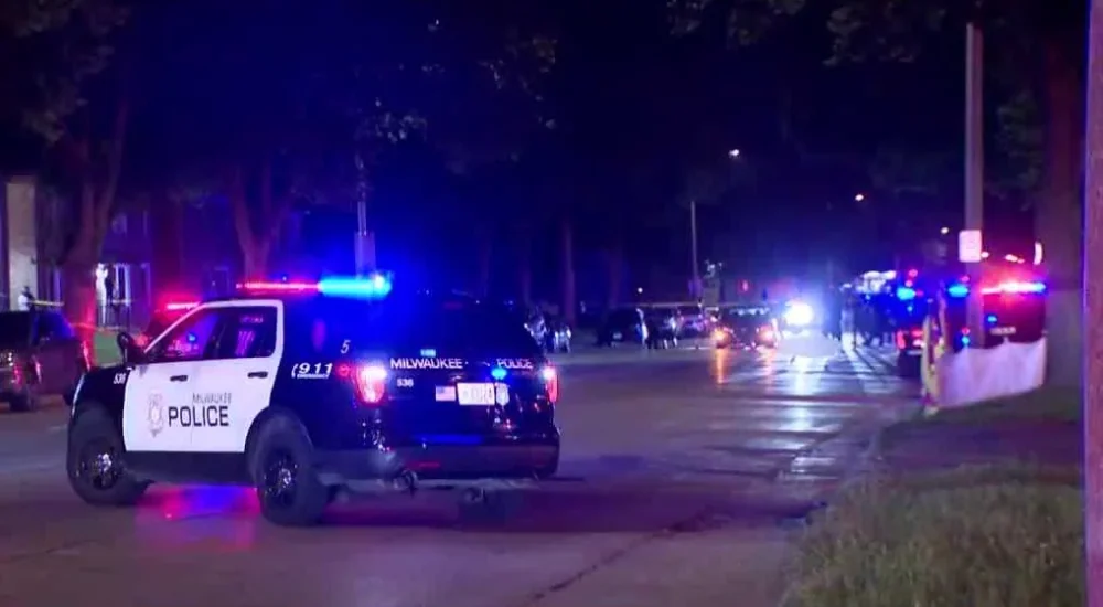Police investigate a nighttime hit-and-run crash on a Milwaukee street