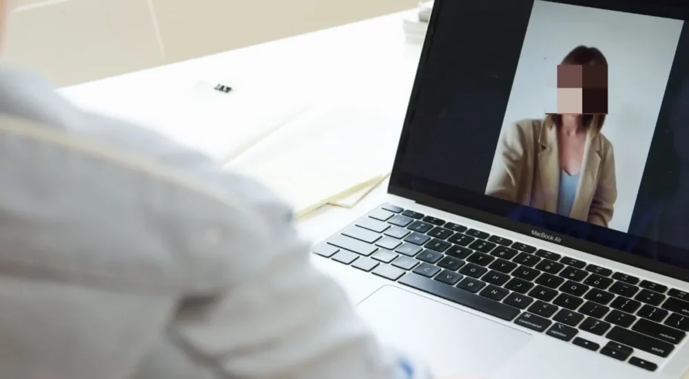 A worried worker at a desk thinking about workplace illness and family health