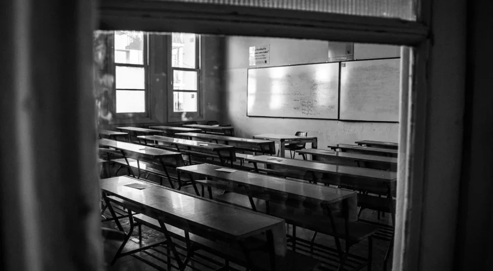 A parent walking a school hallway after a classroom visit and a campus warning sheet