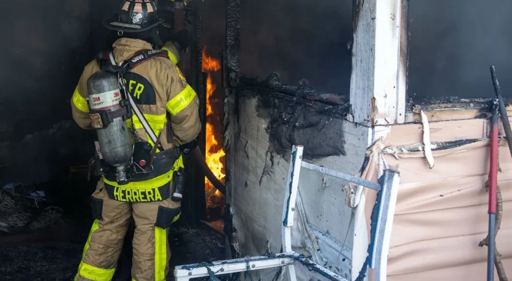 Firefighters respond to a mobile home fire in Palm Beach County after a person escaped through a window
