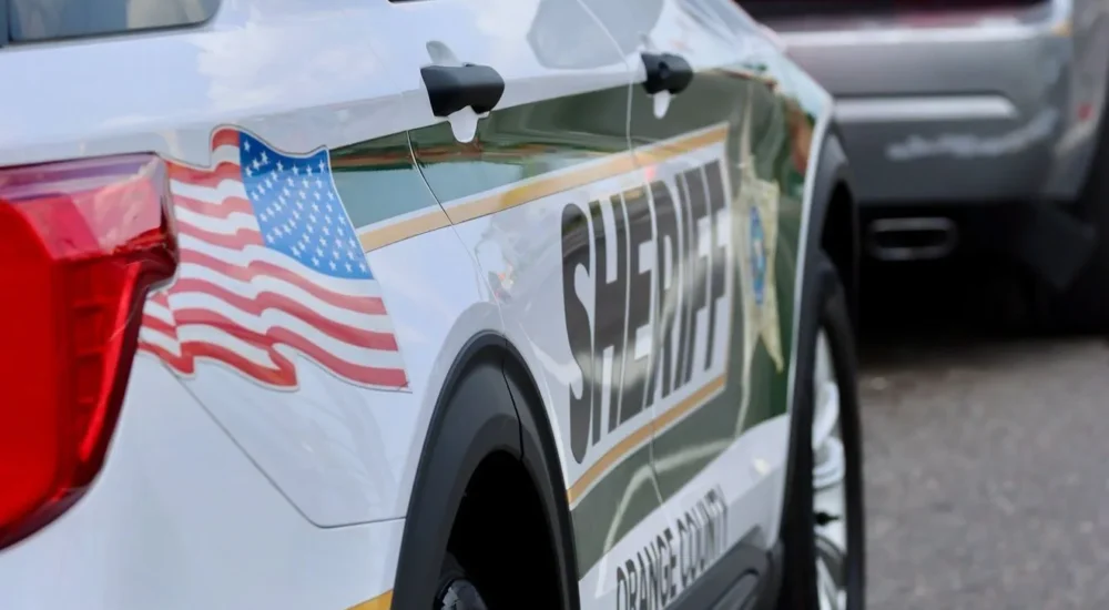 Orange County Sheriff's Office vehicle near a roadside scene in Apopka, Florida