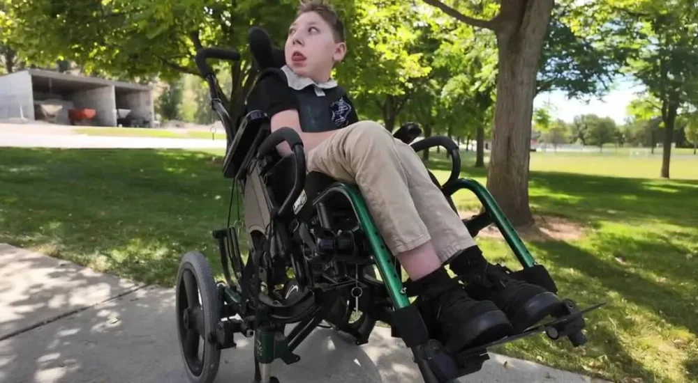 Trexton Lee’s family poses with a wheelchair-accessible van bought with community support