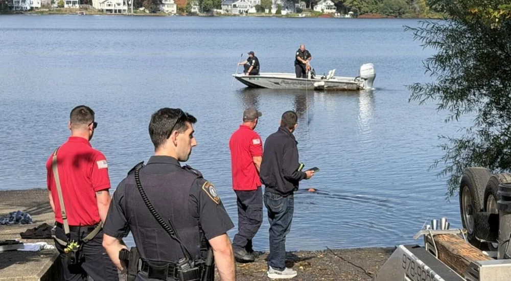 Police and firefighters at Chebacco Lake after a car sank at a boat launch